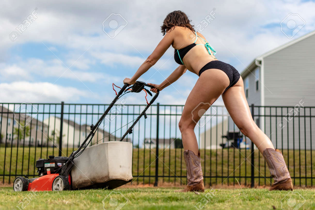 105088918-a-gorgeous-brunette-model-cutting-the-grass-in-a-bikini-and-boots.jpg