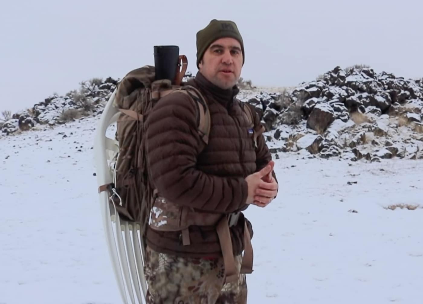 The Eberlestock Gunslinger 2 pack is shown fully loaded with a rifle in the scabbard, snowshoes strapped to the exterior, and survival gear packed inside for a winter mountain hike. The Eberlestock Gunslinger 2 review tests the pack as a complete integrated system rather than evaluating individual features in isolation. Exterior cinch straps secure snowshoes firmly to the outside of the pack without interfering with rifle access or balance. Tactical packs for the SOCOM 16 rifle must accommodate additional winter equipment beyond the firearm itself. The main compartment organizes cold weather layers, food, shelter components, and cook gear without compromising the overall load balance. A fully loaded winter pack system reveals how well the aluminum frame and hip belt manage combined weight over elevation. Hands free carry of both rifle and snowshoes allows the backcountry rifleman to move efficiently through deep snow terrain. The Gunslinger II transforms from a rifle carrier into a complete winter survival and mobility platform when fully configured. Purpose built tactical backpacks earn their reputation by performing as a unified system rather than a collection of separate features.
