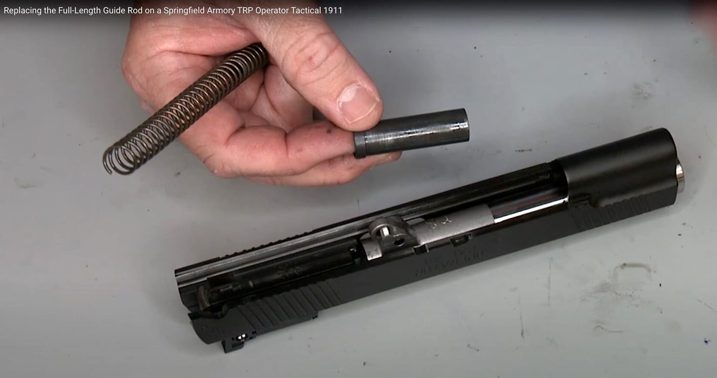The author shows the OEM plug he uses during the replacement of the full length guide rod on his Springfield TRP Operator.