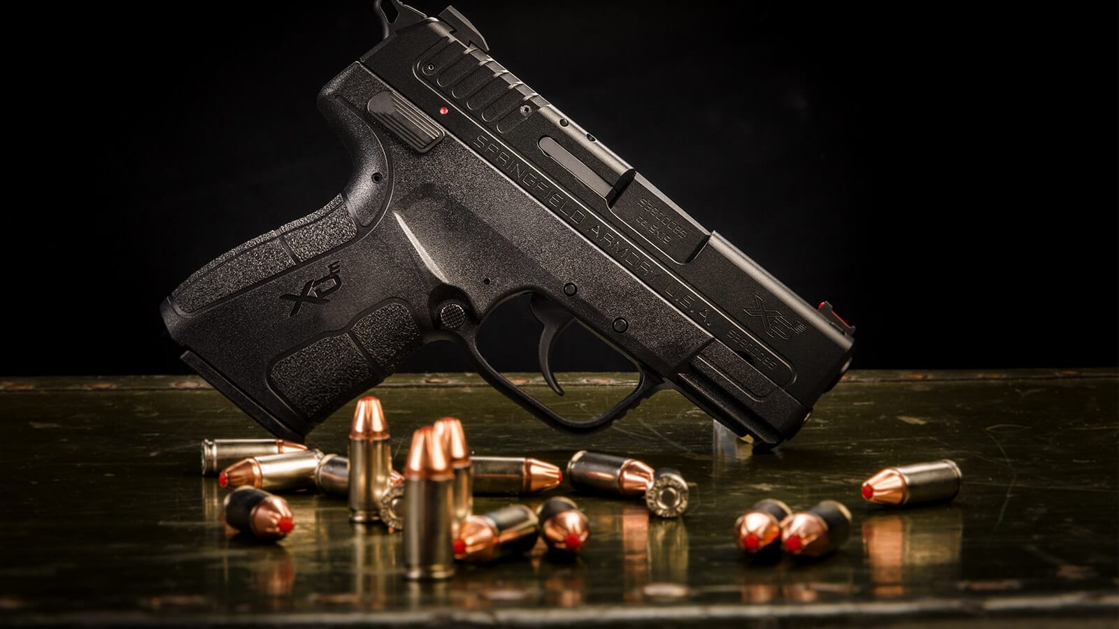 Springfield XD-E with 9mm Hornady ammunition on table