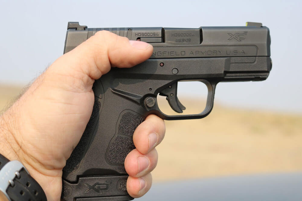 In this photograph, the author demonstrates the bore axis when the 9mm pistol is held in his hands.