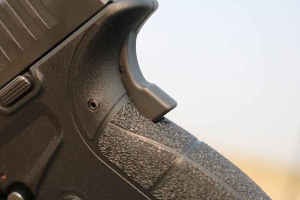 In this image we see the grip safety on the Springfield Armory, Inc. <span class='nowrap'>XD-S</span>. It is similar to the grip safety on the M1911 pistol.