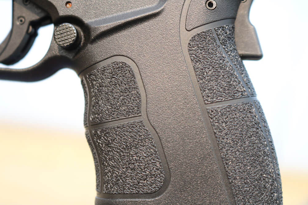 Here, the author is showing us the grip texture on the semi-automatic pistol.