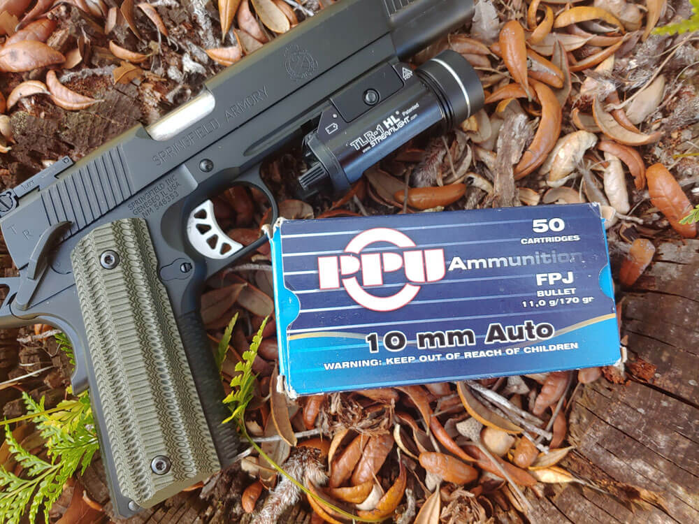 In this photo, the author shows us his 6" Springfield Armory TRP 10mm pistol with PPU ammo.