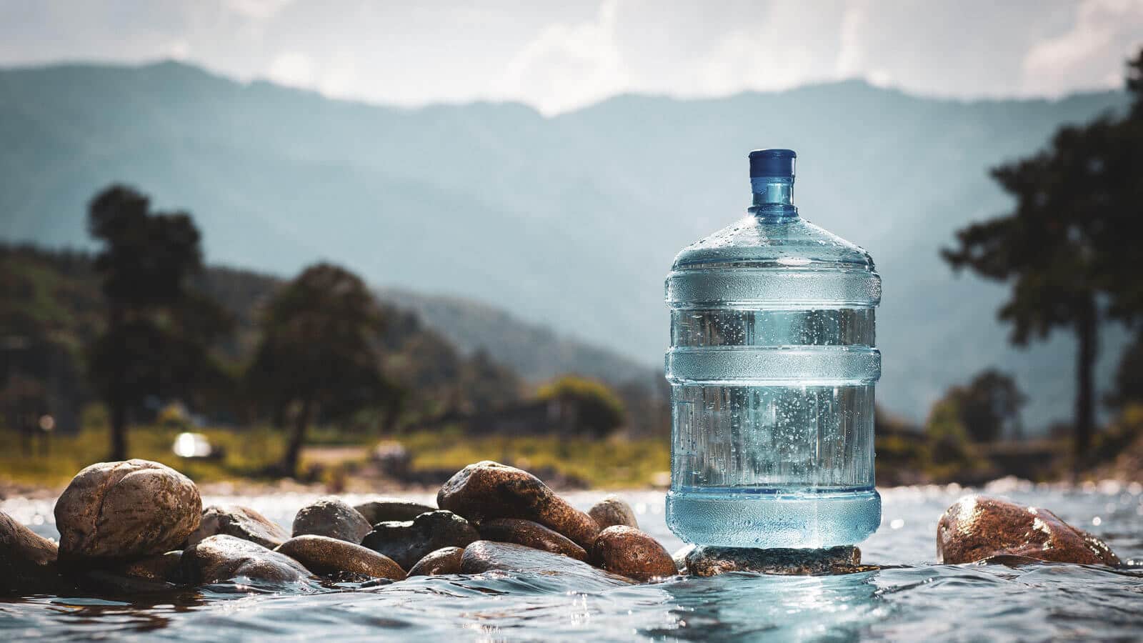 Five gallon water bottle next to river