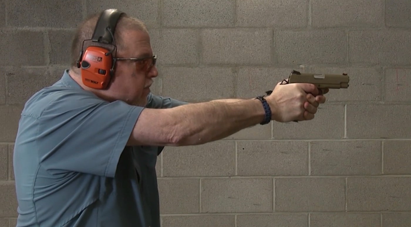 ALT Text 1:
The author stands in a shooting lane at C2 Tactical's indoor range, actively engaging targets with the EMP4 while demonstrating proper shooting fundamentals and evaluating the pistol's performance characteristics. The EMP4 demonstrates excellent accuracy at indoor range distances. Springfield Armory EMP4 handles varied ammunition reliably. Compact 1911 pistols require thorough range testing. The EMP4 feeds different brands without hiccups. Mini 1911 designs prove themselves through live fire evaluation. Springfield's compact pistol rewards shooters with consistent performance. The EMP4 maintains controllability during extended shooting sessions.