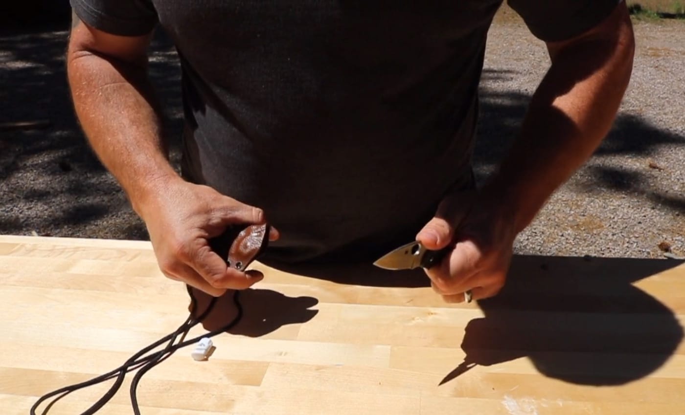 In this photo, the author shows how he holds the knife to create maximum cutting power by placing his thumb on the jimping.