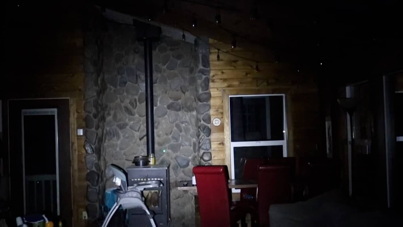 A nighttime scene showing the bright beam from the Viridian X5L illuminating a dark area with visible light spread and intensity. The Viridian X5L review tests actual low-light performance. Light and laser unit output determines identification capability. Green lasers complement high-lumen illumination systems. Defensive encounters frequently occur in darkness. The X5L produces 500 lumens for indoor use. Non-standard drills simulate realistic lighting conditions. Home defense requires positive threat identification. Combined units provide both aiming and illumination solutions.