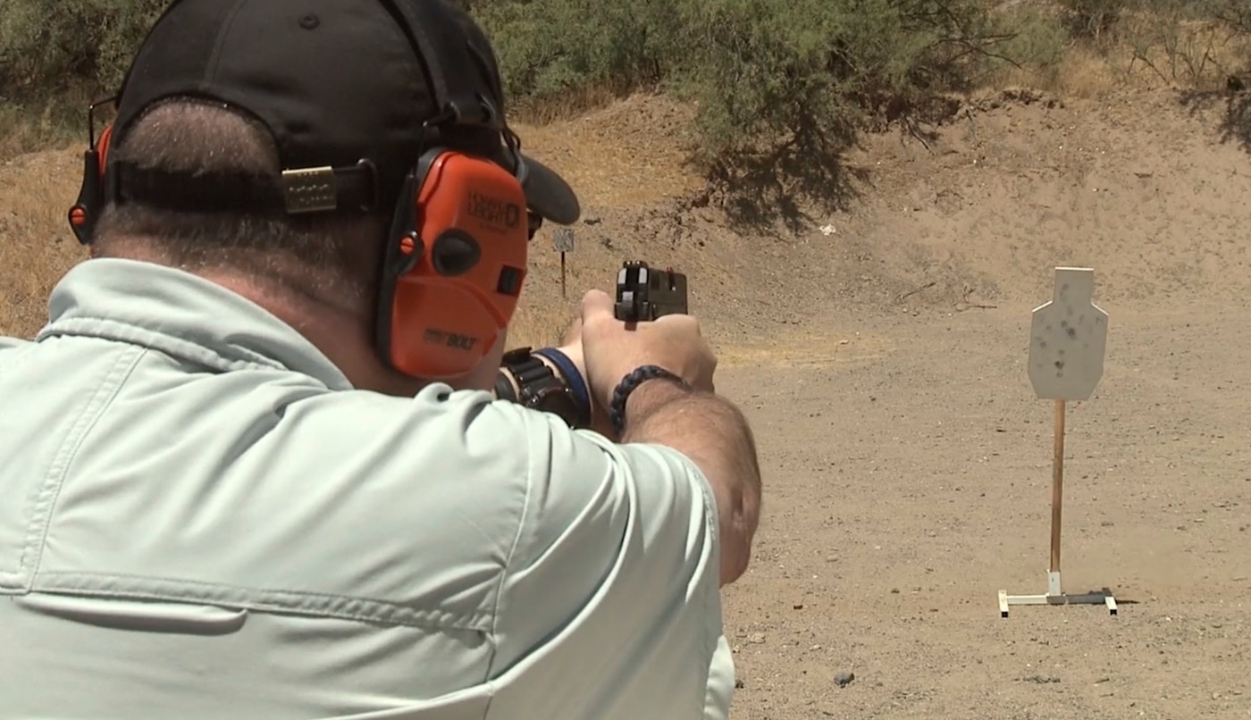 A shooter's hands grip a Springfield Armory XD-E pistol in firing position with proper trigger finger placement on the double-action trigger. The double strike capability of Springfield XD-E provides instantaneous malfunction diagnosis without manual cycling. Springfield Armory XD-E shooters can press through light strikes by simply pulling the trigger again. DA/SA pistols offer tactical advantages when ammunition quality varies or conditions aren't ideal. The XD-E hammer system delivers second chances against problematic primers in defensive situations. Compact 9mm carry guns with double-action capability reduce negligent discharge risks during holstering. Deliberate first-shot trigger pulls enhance safety without sacrificing follow-up speed in single-action mode. The Springfield XD-E decocker enables confident hammer-down carry for appendix positions. Type one failures resolve immediately when double strike mechanisms allow repeated primer impacts.
