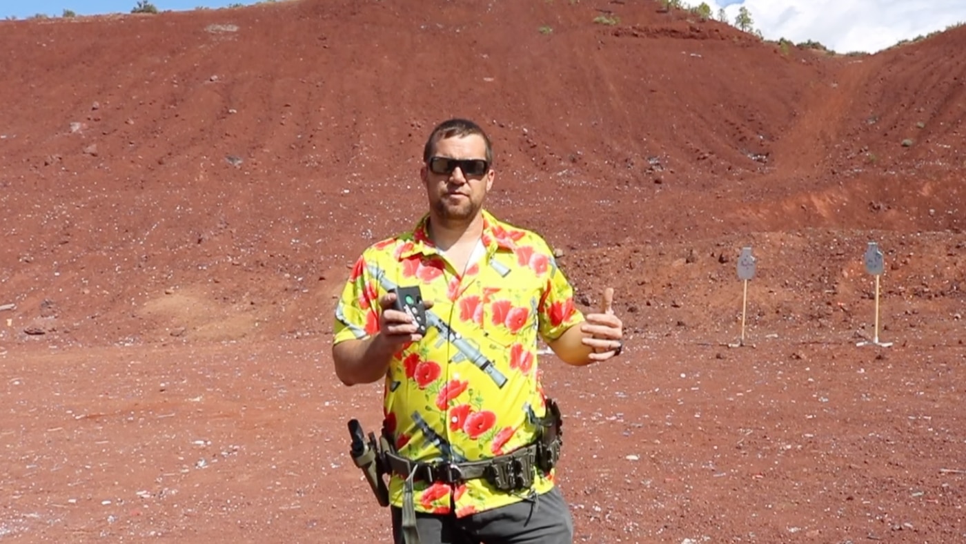 author showing the PACT Club Shot Timer III while at the shooting range