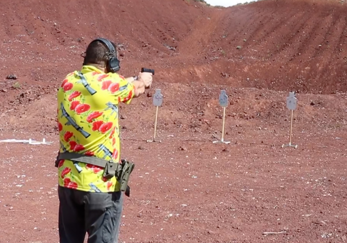 author using PACT Club Shot Timer III during defensive shooting training