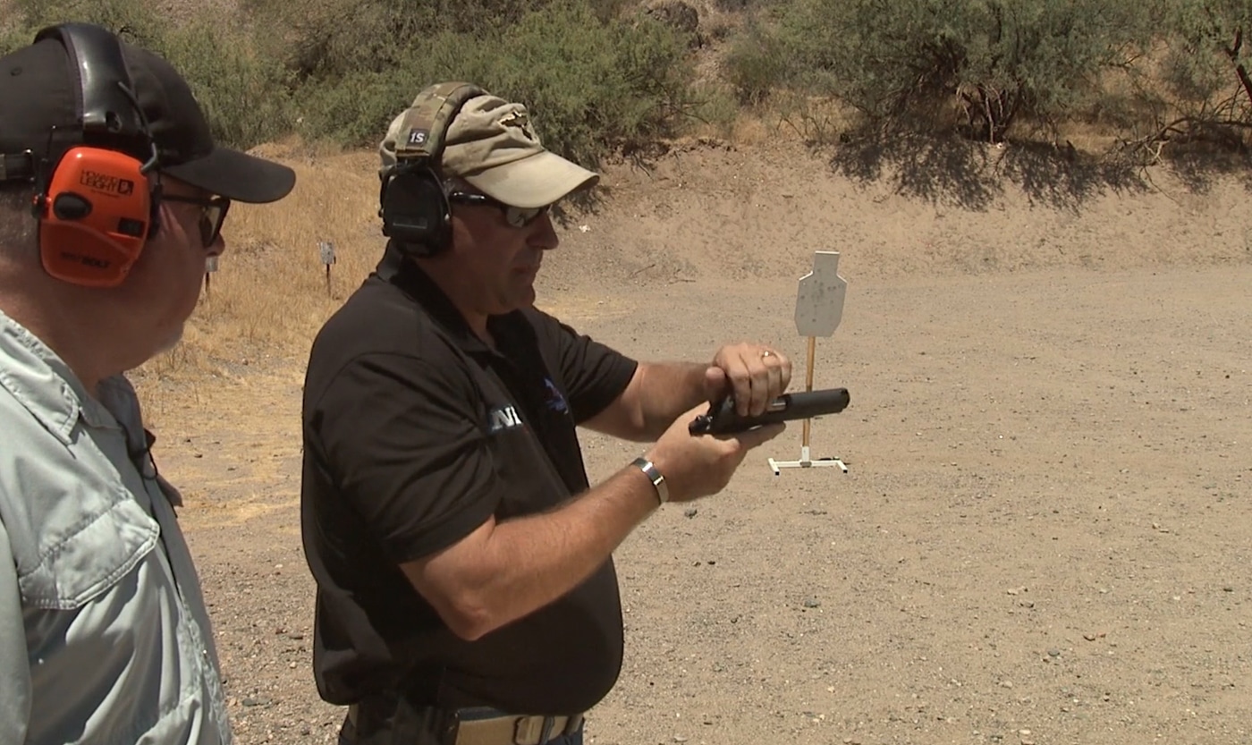 An instructional image demonstrating proper grip adjustment while executing a one-handed slide release on a semi-automatic pistol. One handed malfunction clearance challenges shooters initially. Clearing pistol jam with one hand becomes natural with practice. Slide release access requires grip modification. Support hand unavailability creates training opportunities. Handgun users face realistic limitations. Tactical shooting drills address injury contingencies. Range practice builds muscle memory. Defensive pistol skills include adaptive techniques.
