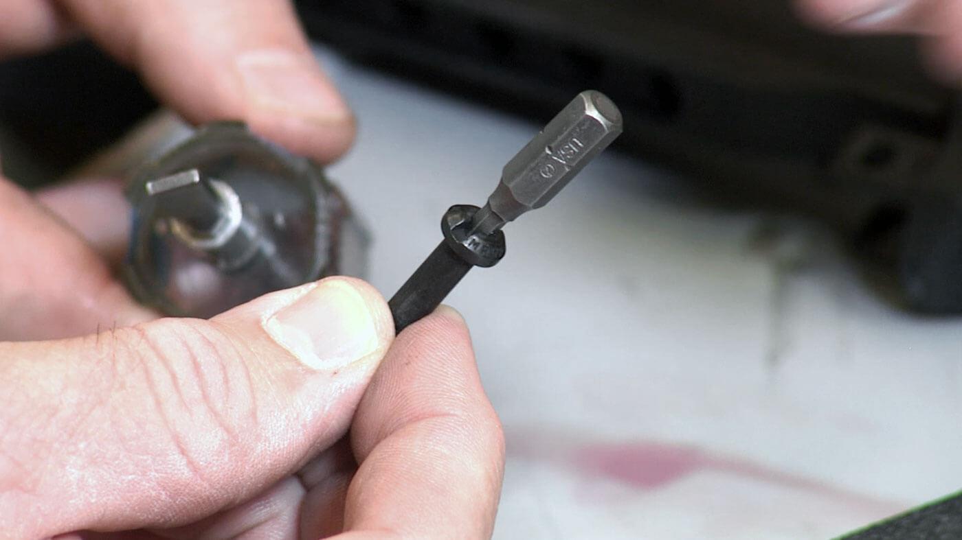 In this digital image, we see an armorer screwdriver bit fitted into a screw head. For a civilian version of a M4 carbine or M16 rifle, the Magpul Industries non-collapsing stock option for mil-spec buffer tubes is a solid option that is easy to install.