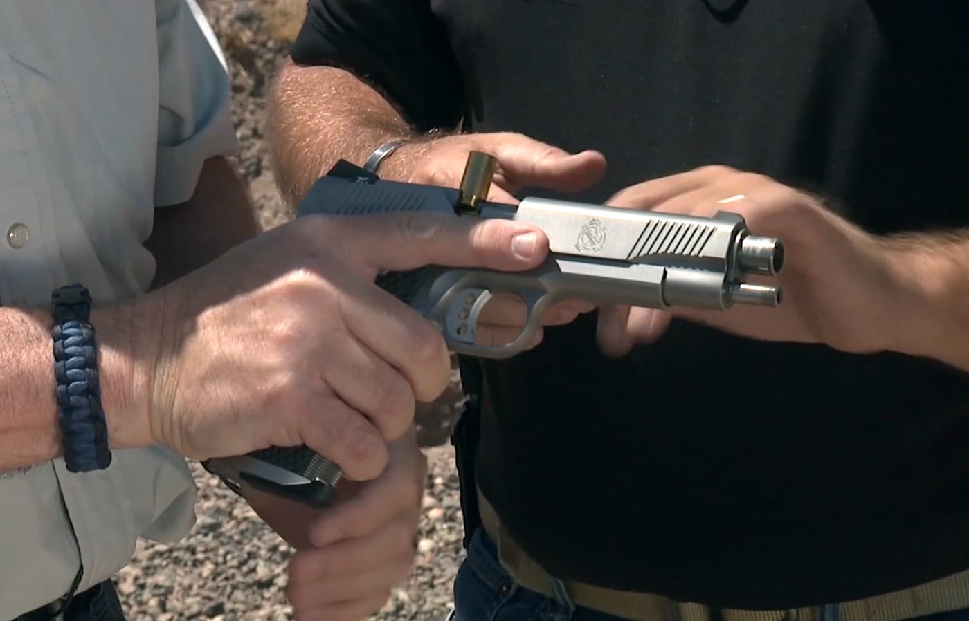 author assessing a pistol malfunction