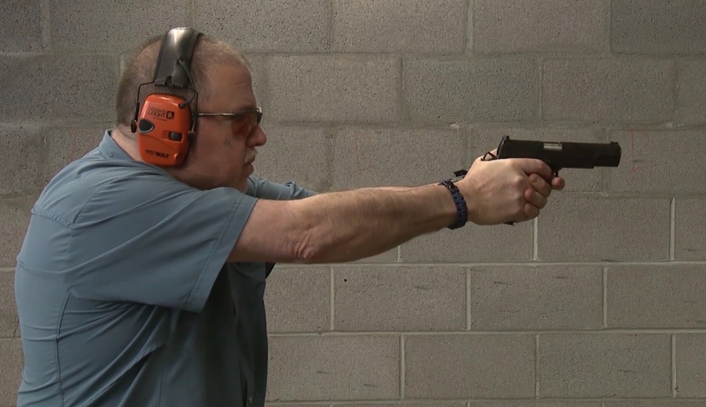 testing the Springfield Armory 1911 at an indoor shooting range