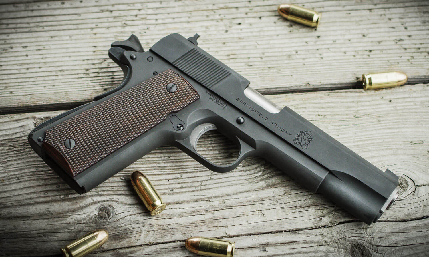 In this photo is a Springfield Armory M1911 Mil Spec .45 ACP pistol. 	The original Colt M1911 is a single-action, recoil-operated, semi-automatic pistol chambered for the .45 ACP cartridge. The pistol's formal U.S. military designation as of 1940 was Automatic Pistol, Caliber .45, M1911 for the original model adopted in March 1911, and Automatic Pistol, Caliber .45, M1911A1 for the improved M1911A1 model which entered service in 1926. They were used extensively by the Tunnel Rats in the Vietnam War.