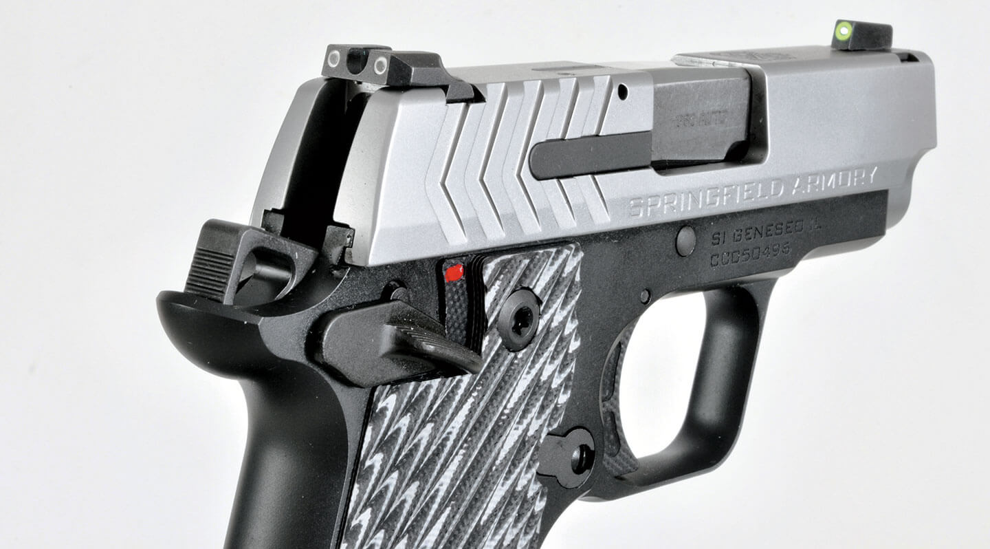 Close-up view of the Ameriglo Pro-Glo sights on the stainless steel 911 slide