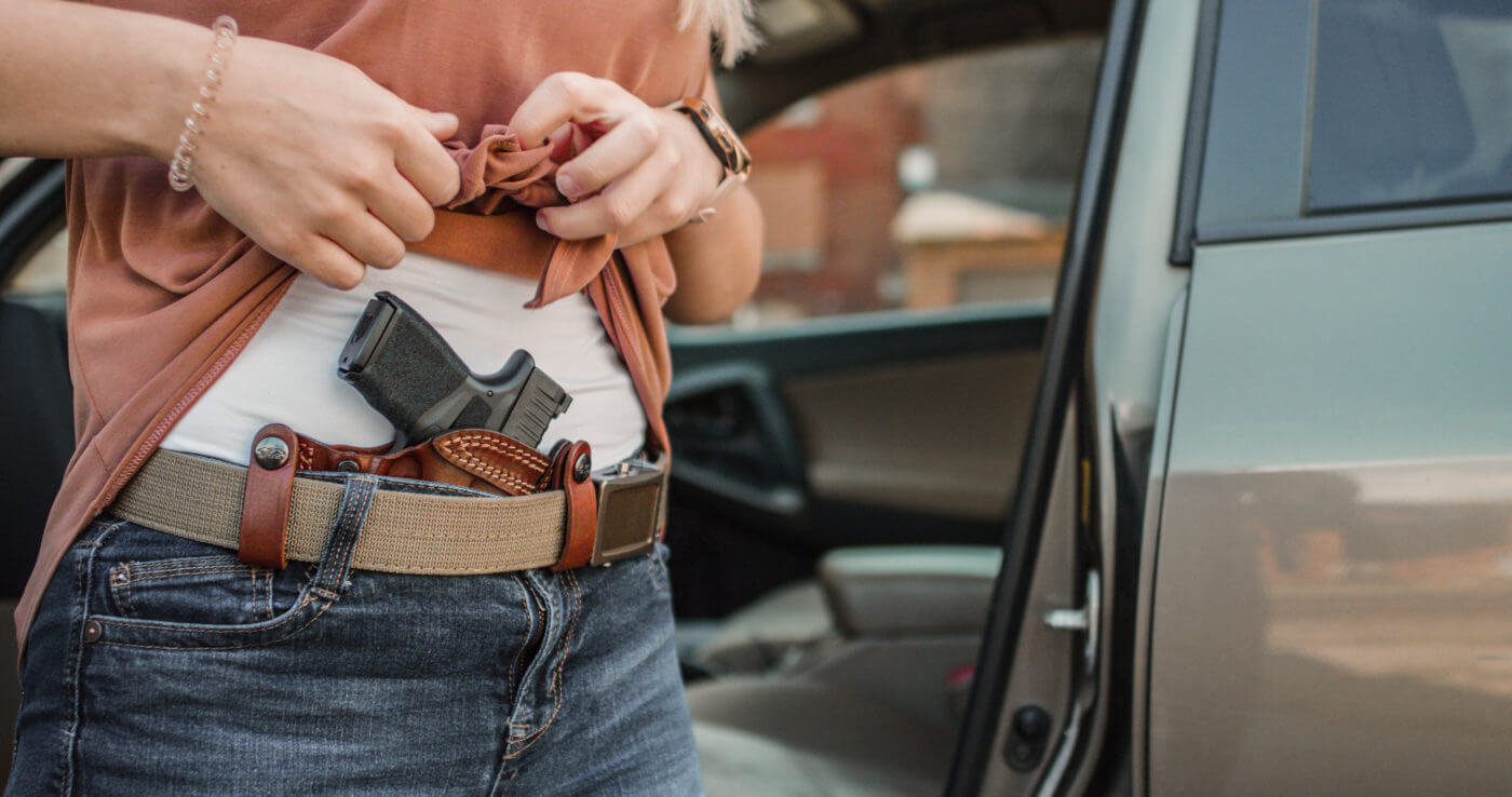 Woman drawing Hellcat pistol from concealment