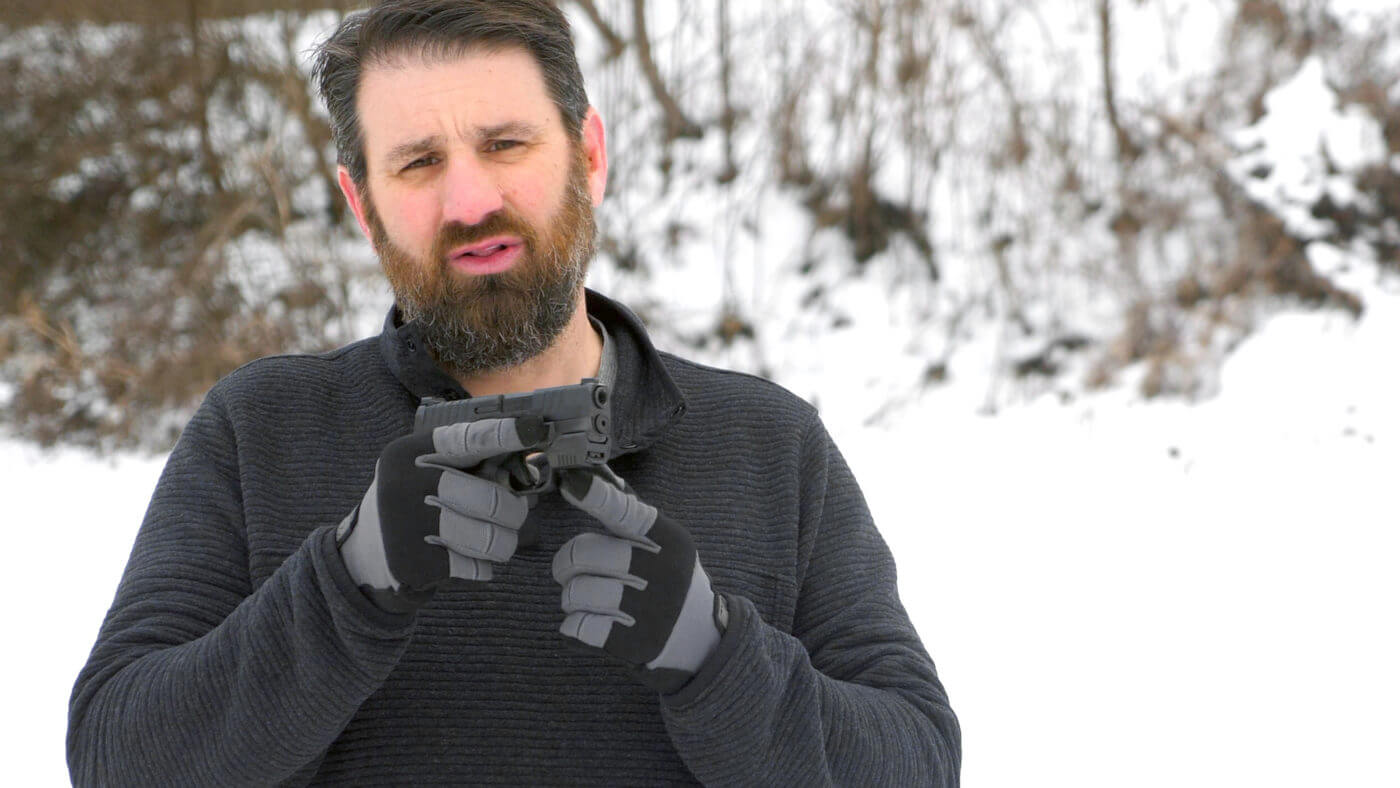 Paul Carlson demonstrating how the Mantis X3 attaches to the Springfield Hellcat's accessory rail