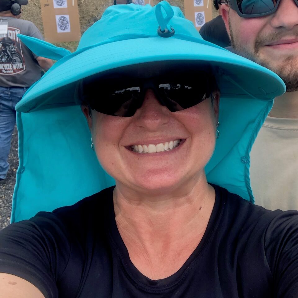 woman wearing sun hat with neck shield on shooting range woman wearing sun hat with neck shield on shooting range