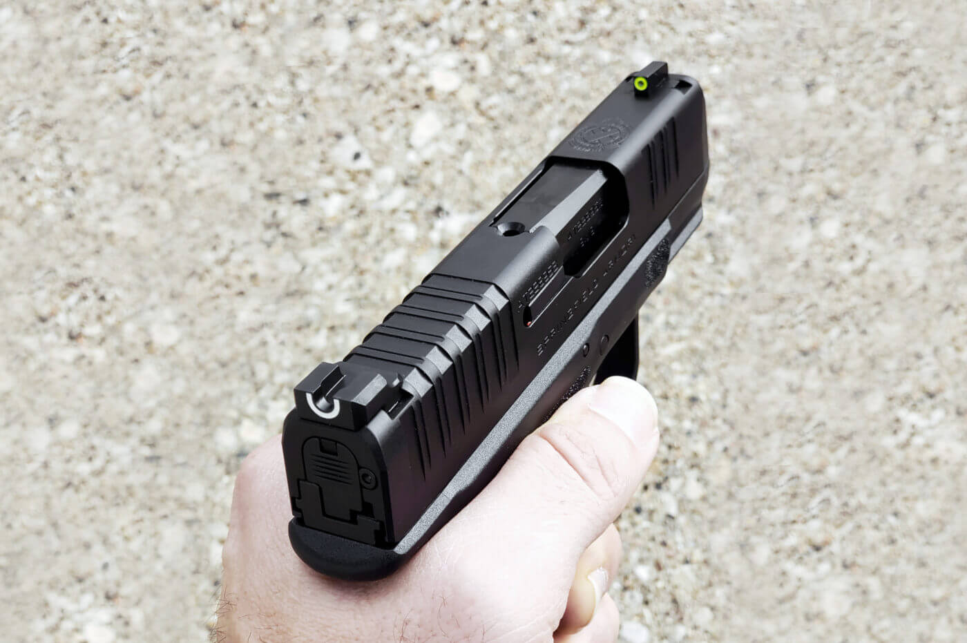 In this photo, the author displays the U-dot sights installed on the Hellcat pistol slide. The front dot sight combines with the rear sight for Springfield Armory 's best sight picture. The sight set is the best set of so-called iron sights on the market with a tritium front sight and a wide U-notch rear sight. Simply put, the Springfield Hellcat comes with the best night sights installed at the factory.