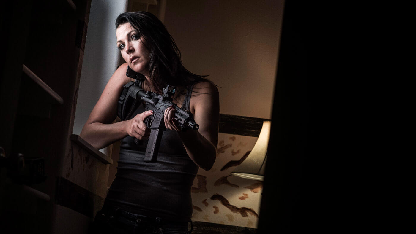 Woman with SAINT pistol during home defense drill