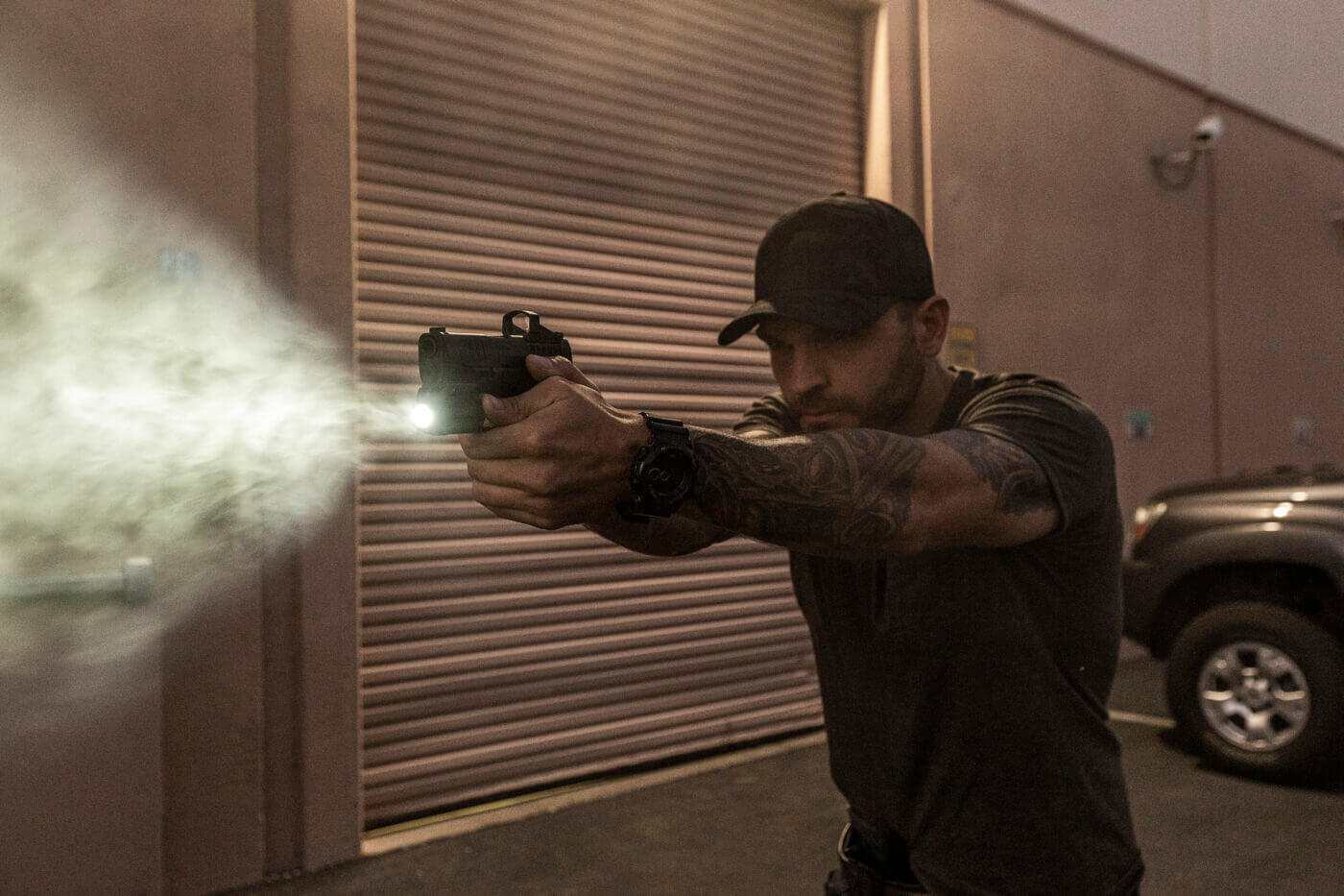 In this image, the author demonstrates low light shooting with the SureFire XSC micro weapon light. It uses a unique lithium-polymer battery and comes with a charging system that is unique in the world of weapon-mounted lights. The charging port is easy to access on all pistols.