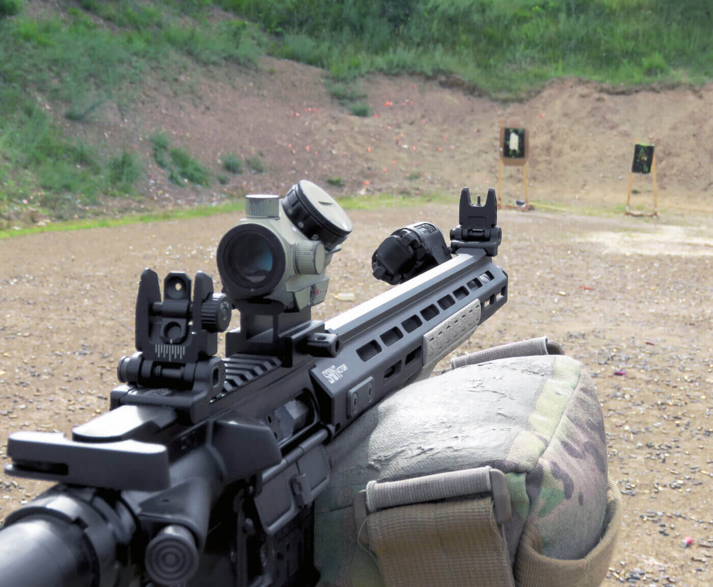 In this photo, the author has his AR-15 on a shooting range to determine his POA and POI at various ranges. These change depending on your zero point. A zero at 25 yards is different from a 300 meter zero, for example. When it comes to your go-to 5.56 carbine, you want to be sure of your scope dope and combat zero.