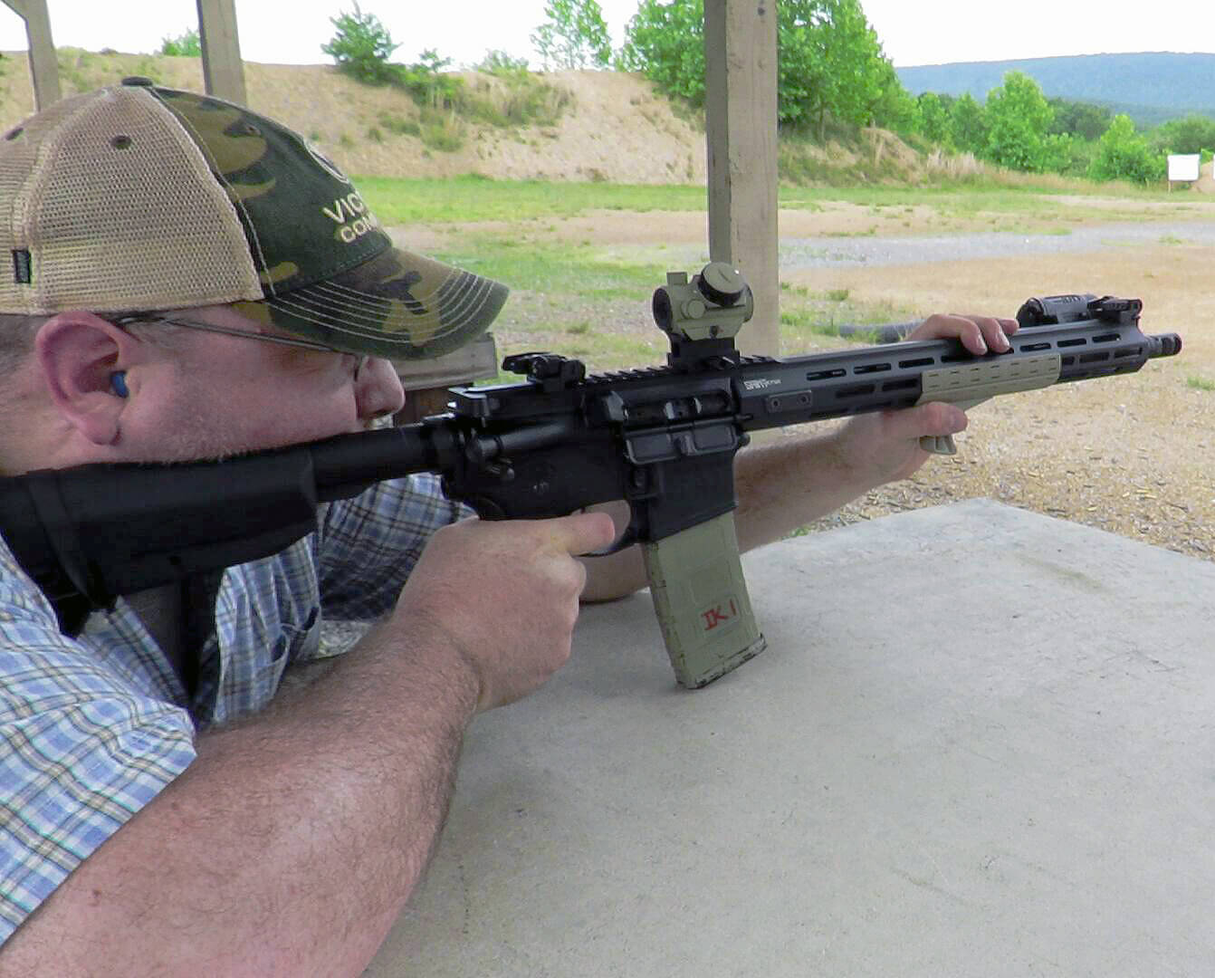 The author is sighting in a non-magnified reflex sight in this photo. Shown is the author's Springfield SAINT AR-15 rifle with a red dot on a riser. You POI at 200 yards is almost certainly different than at 50 yards no matter where you sight in. 