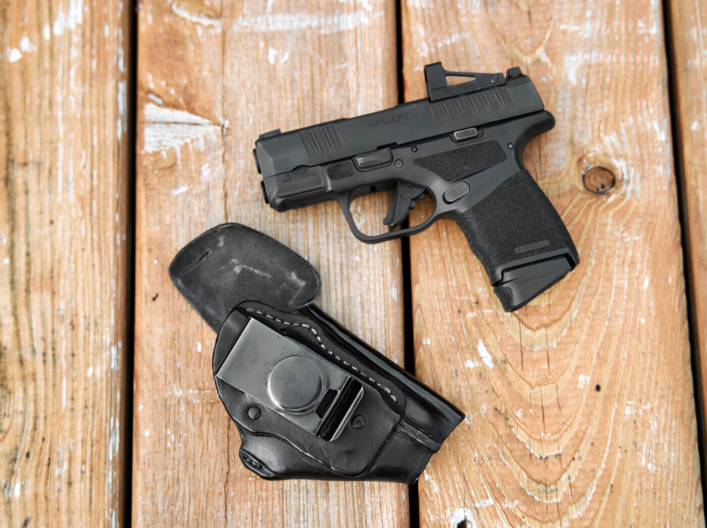 A Springfield Armory Hellcat handgun with a Burdette HC3 holster.