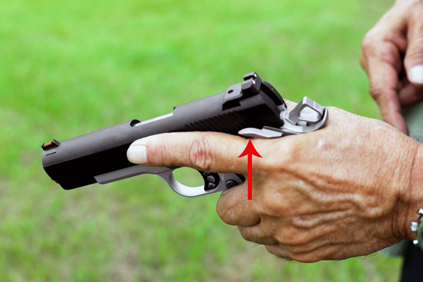 Ayoob shows how to engage the 1911 thumb safety with one hand