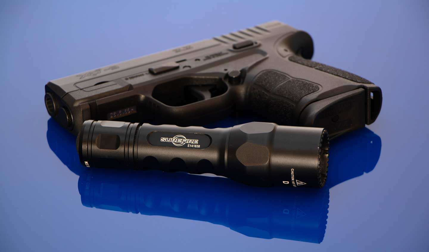 Hand-held home defense flashlight