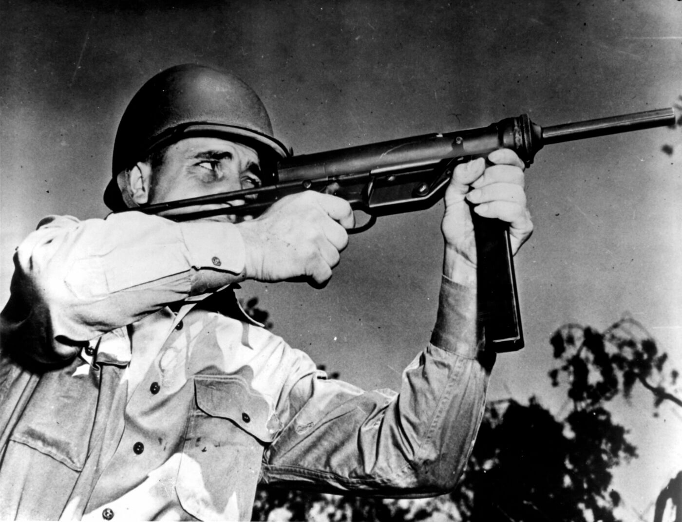 M3 Grease Gun being fired by a soldier in WWII