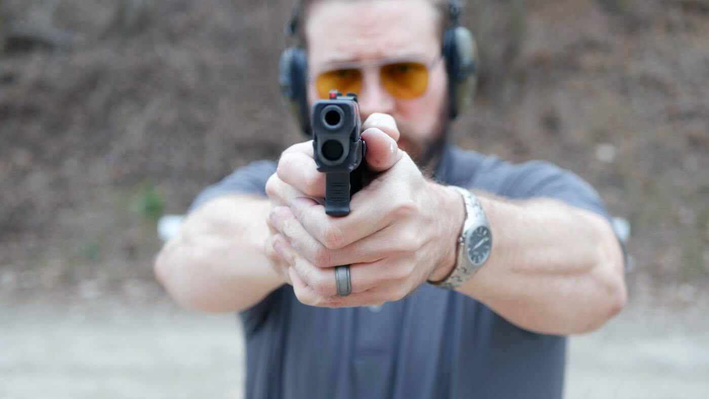 Elbow positioning for recoil reduction when shooting a handgun