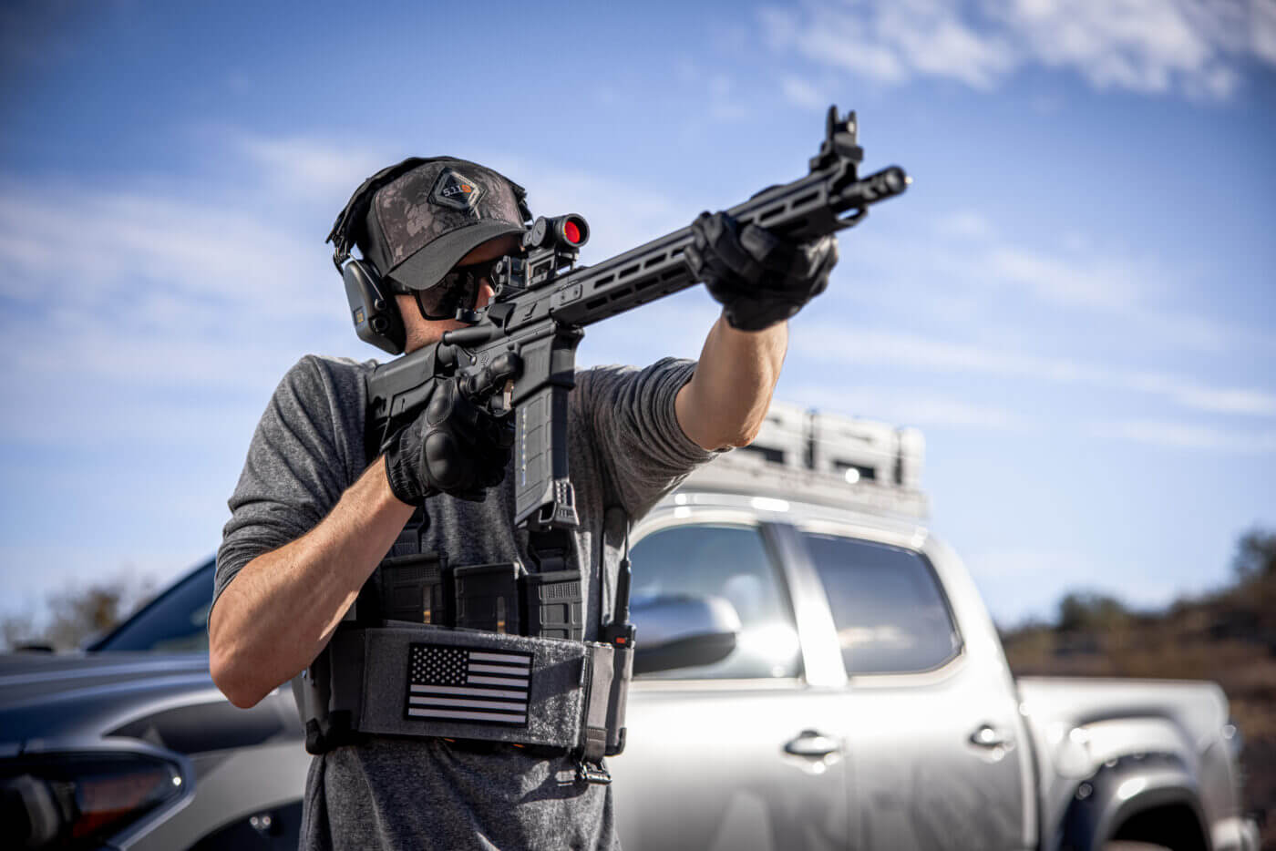 Young man in hat shooting a Springfield AR-15 rifle