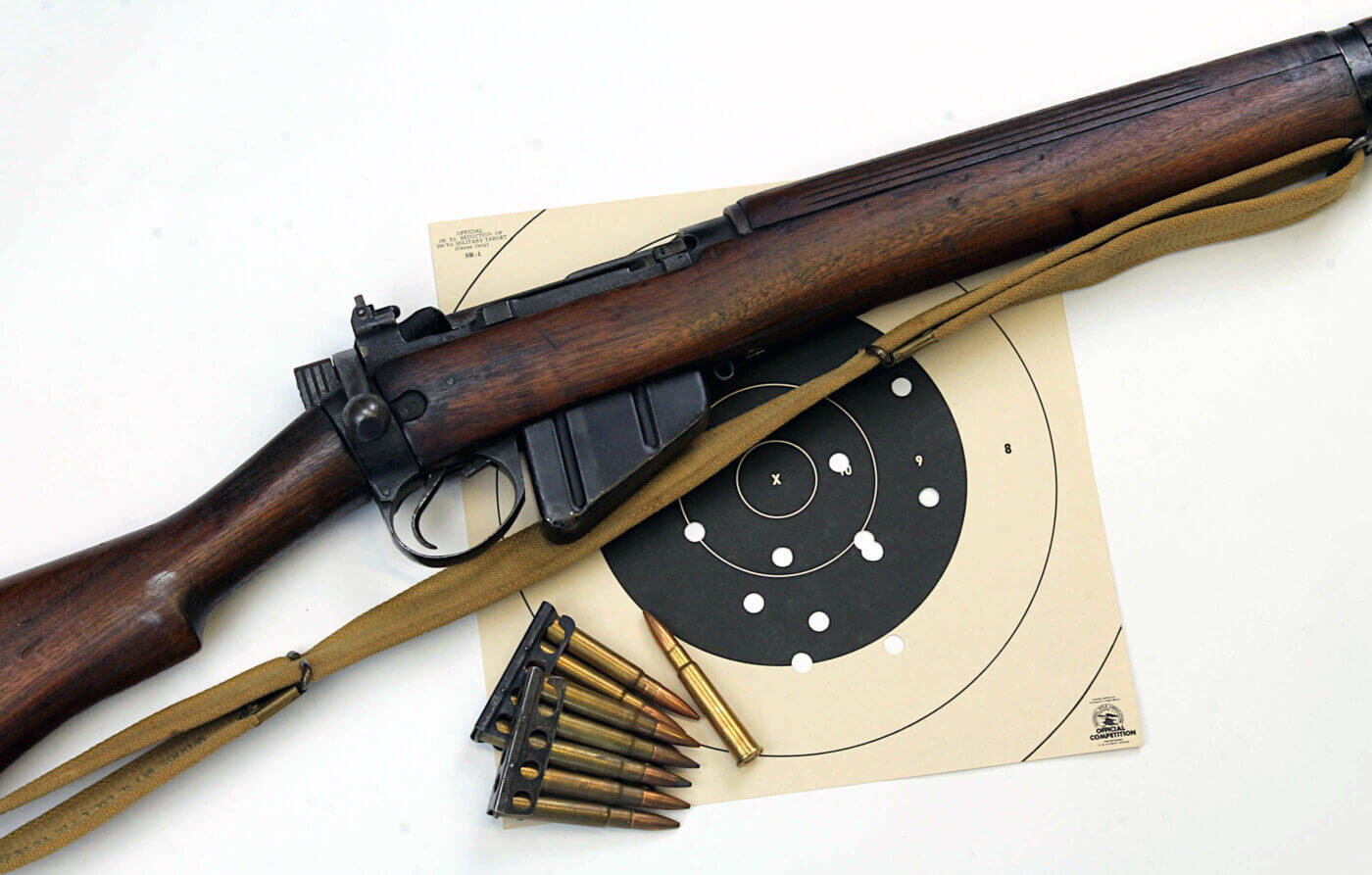 A shooter smiles while firing a military surplus rifle at a Vintage Military Rifle Games event, highlighting the enjoyment of these competitions. The relaxed atmosphere and focus on affordability make the games an accessible hobby for enthusiasts of all skill levels. Surplus rifles, with their rich history and budget-friendly appeal, take center stage in this engaging activity. This photo captures the essence of the Vintage Military Rifle Games, blending fun, history, and marksmanship.
