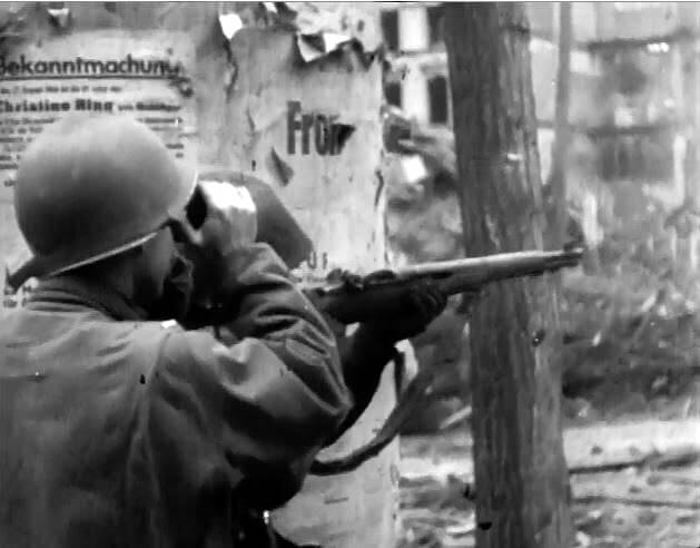 US soldier shooting an M1 Garand sniper rifle