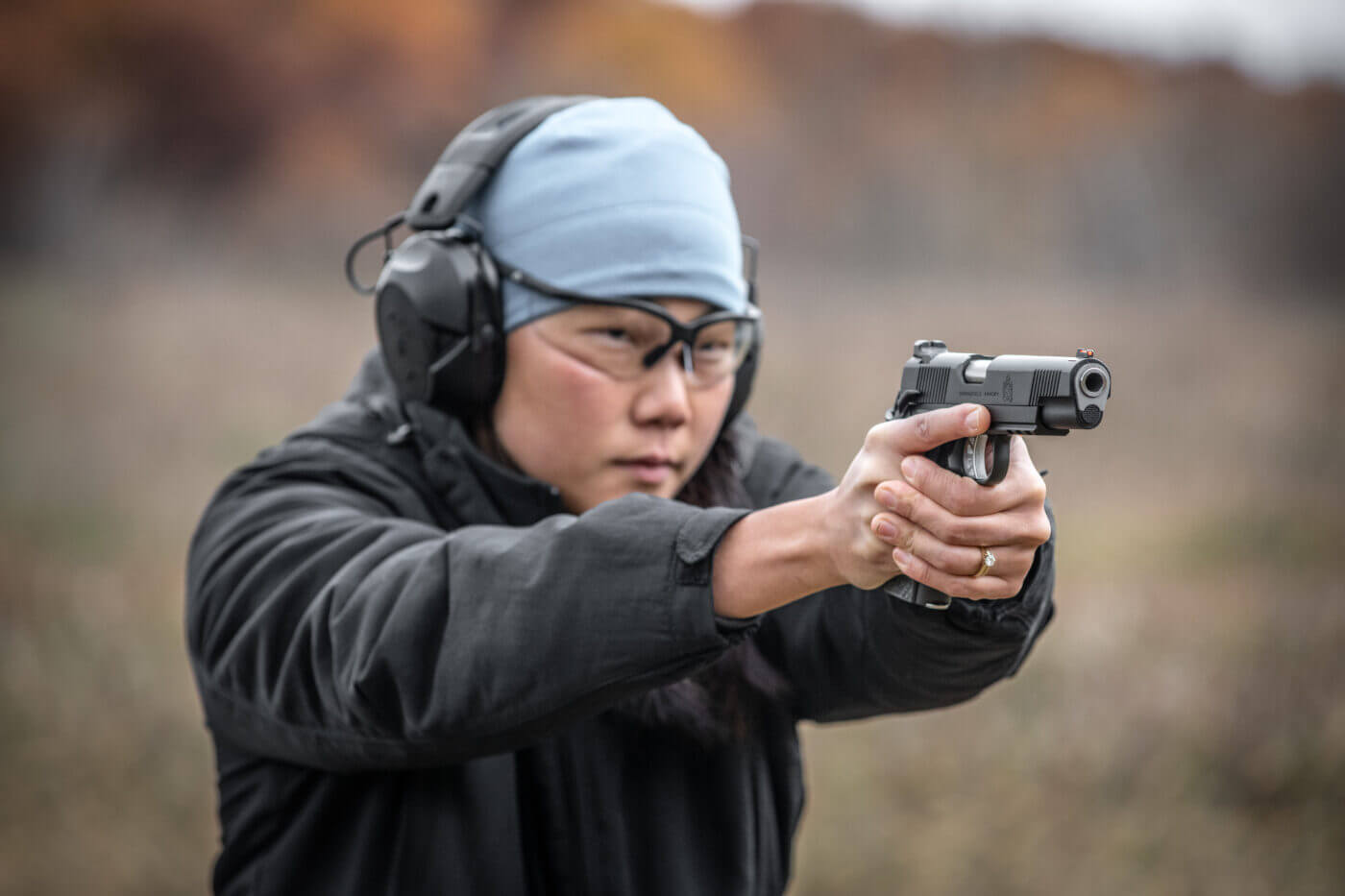 Woman shooting Range Officer Elite 10mm in competition