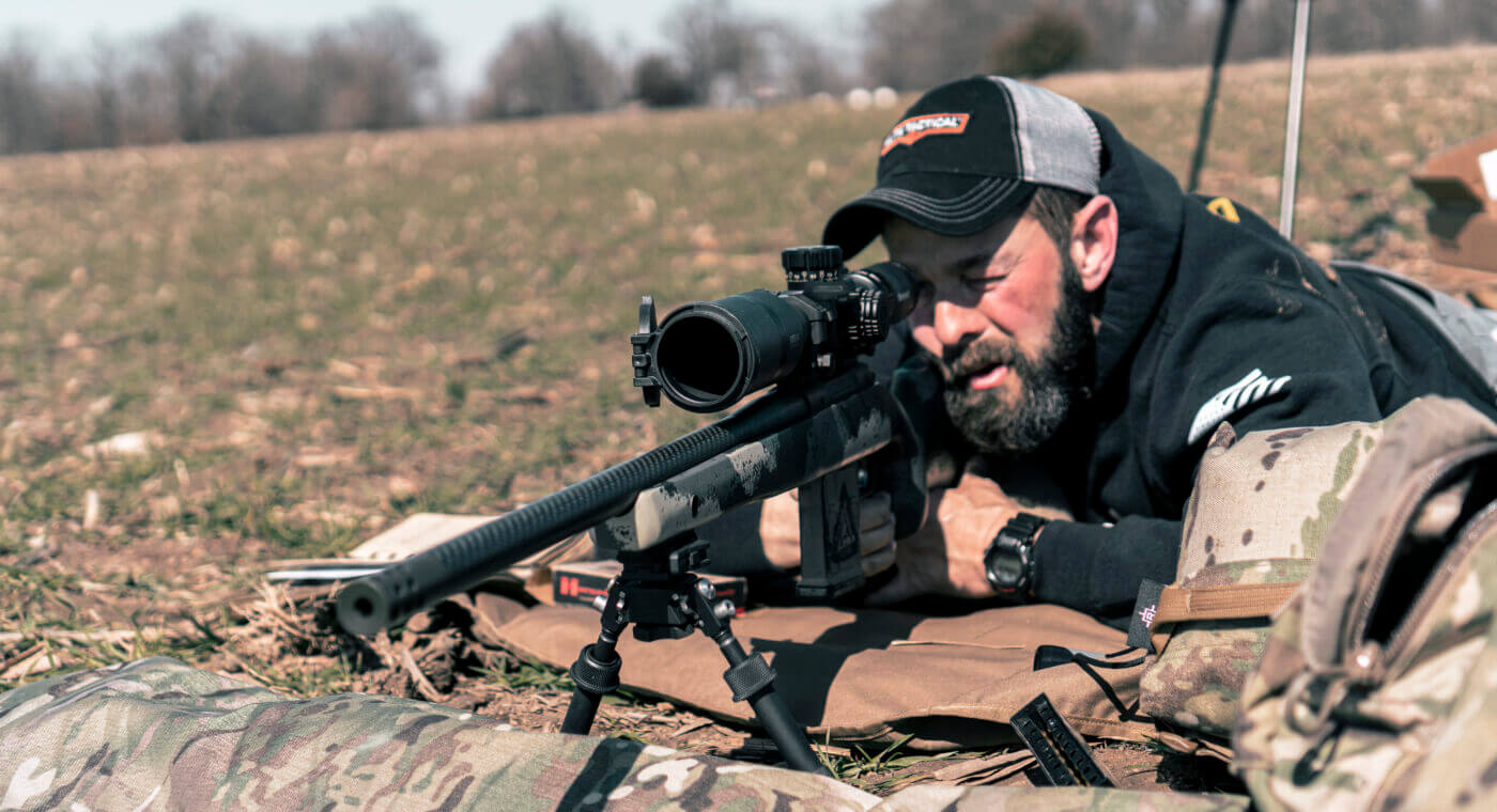 Man shooting Waypoint rifle with Bushnell Elite scope