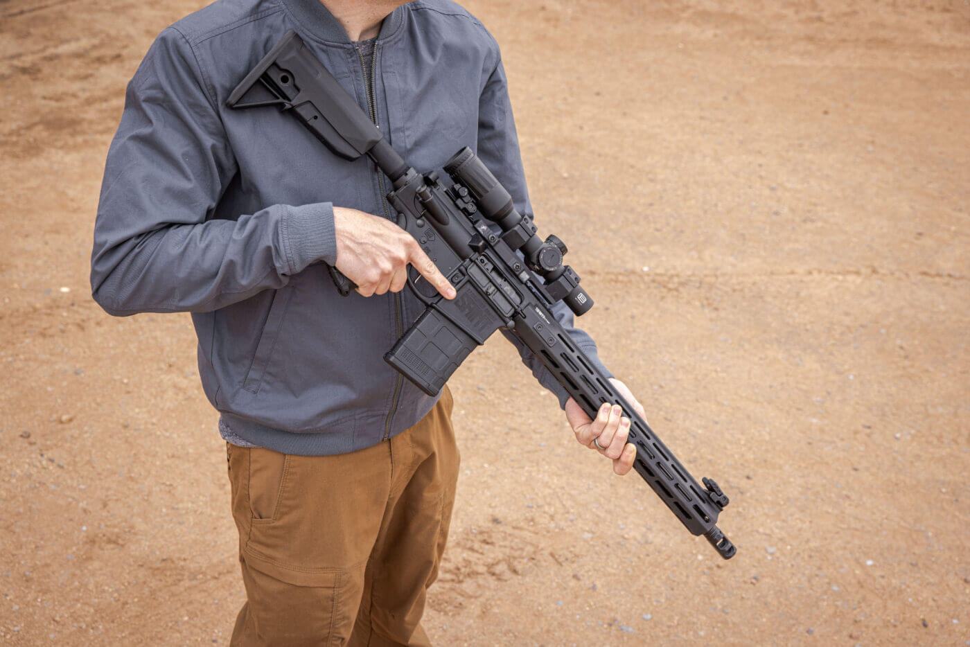 Man holding SAINT Victor .308 rifle