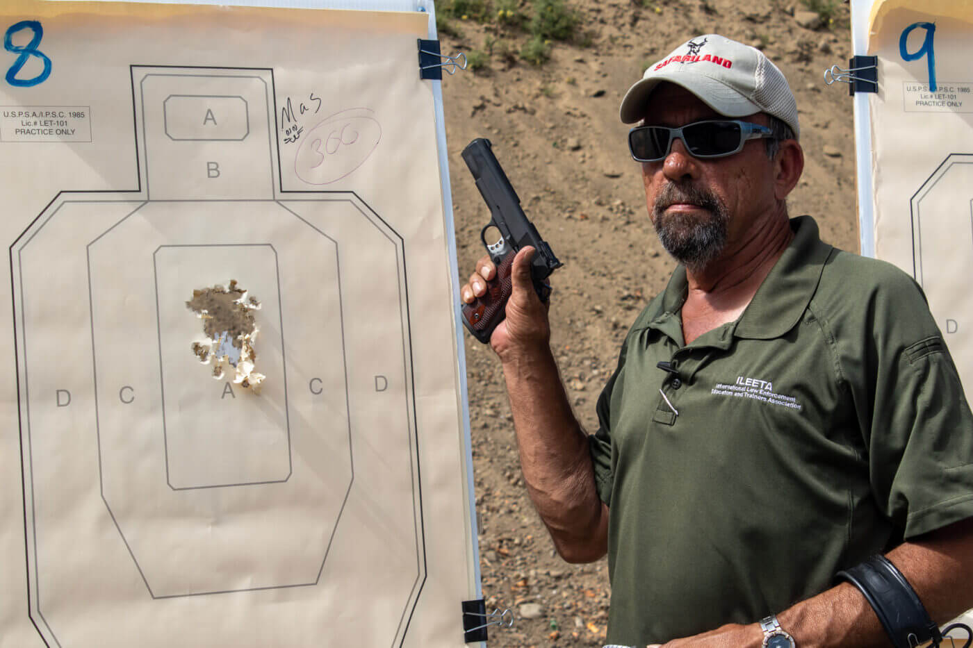 Massad Ayoob with Springfield .45 pistol and ragged target grouping