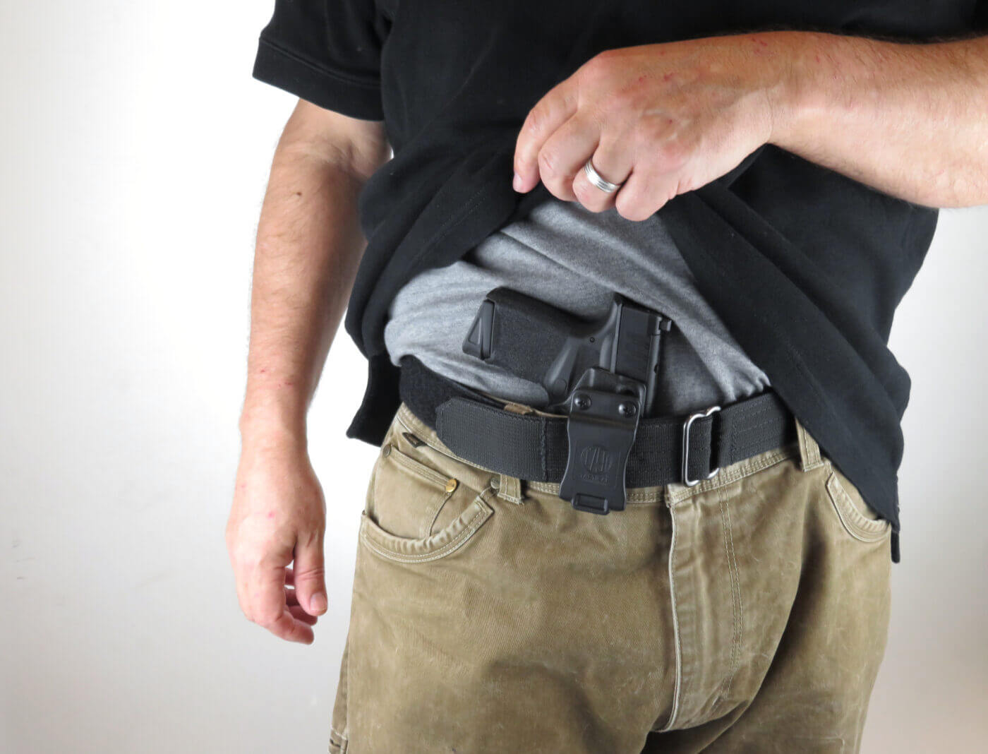 Man showing holster under a shirt