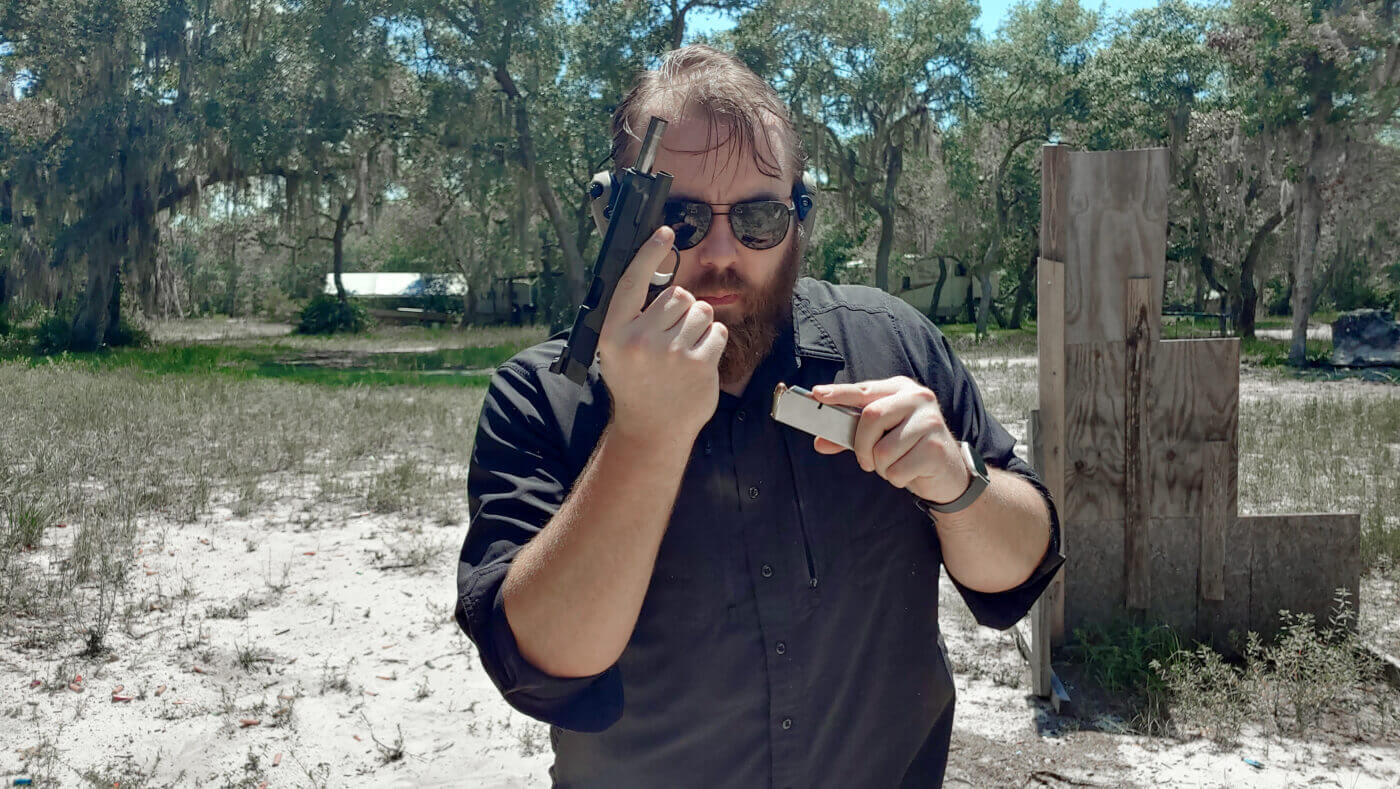 Man demonstrates reload of 1911 in El Presidente drill