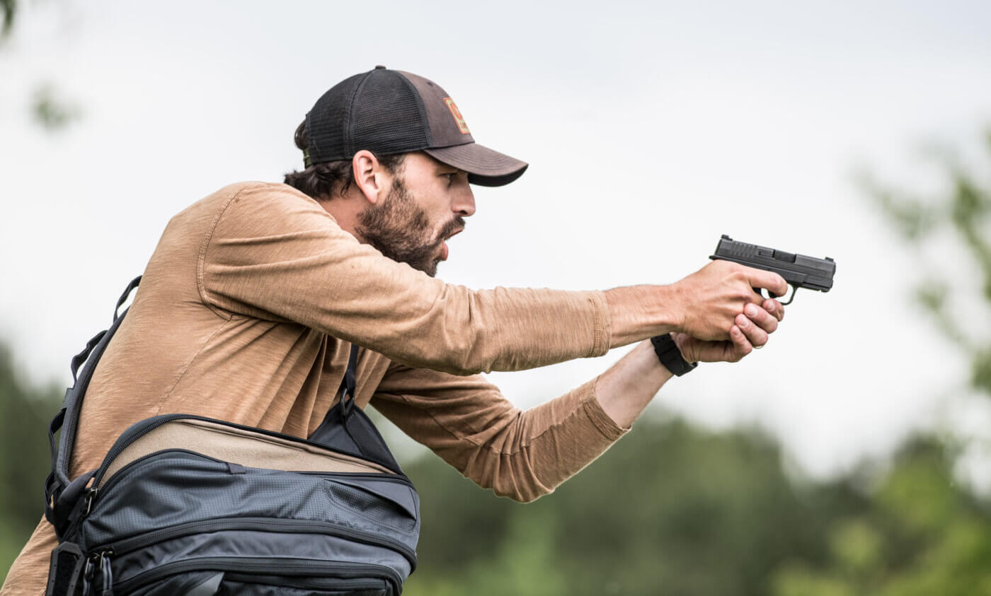 Man shooting a gun to defend himself