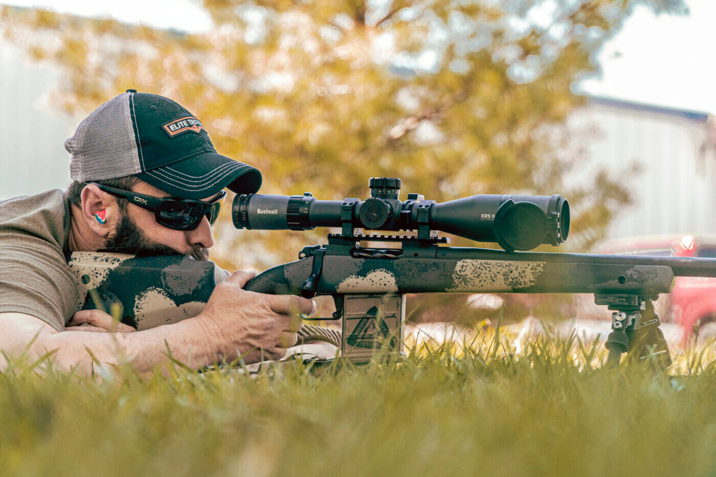 Man shooting a rifle at long range