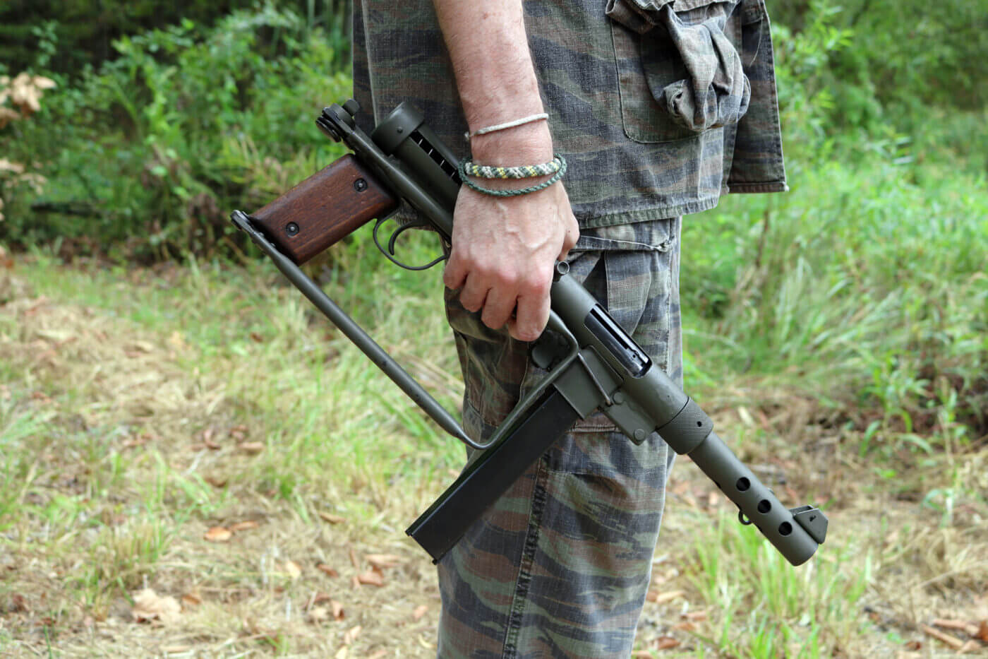 Man holding Swedish K submachine gun folded