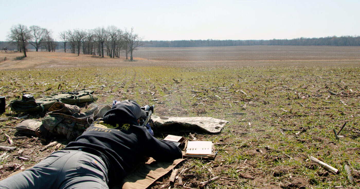 Man shooting long distance from prone position