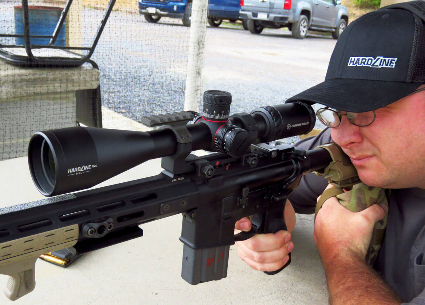 Man shooting with the Crimson Trace hardline rifle scope on SAINT rifle