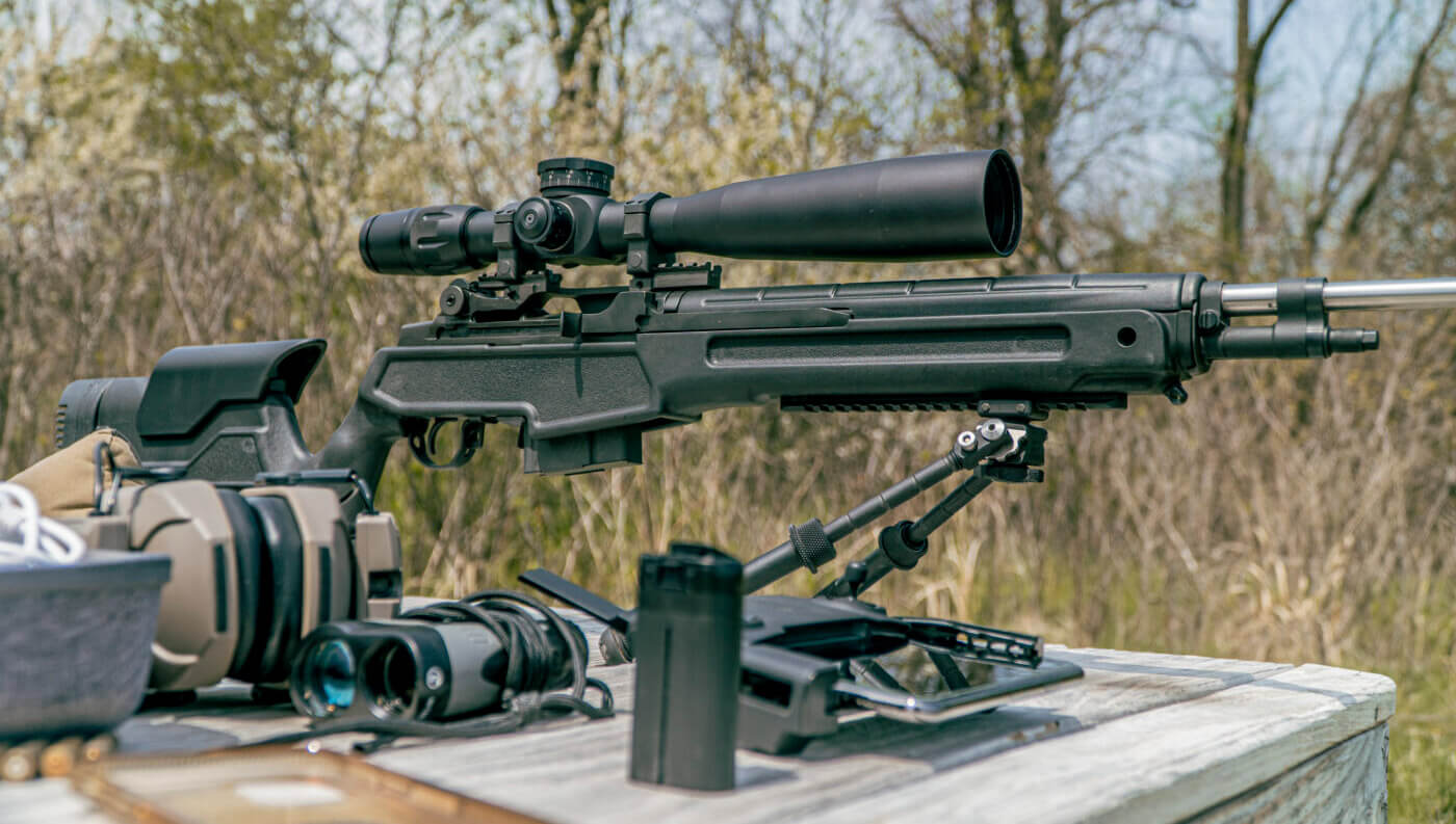 Springfield M1A rifle with scope on table at range