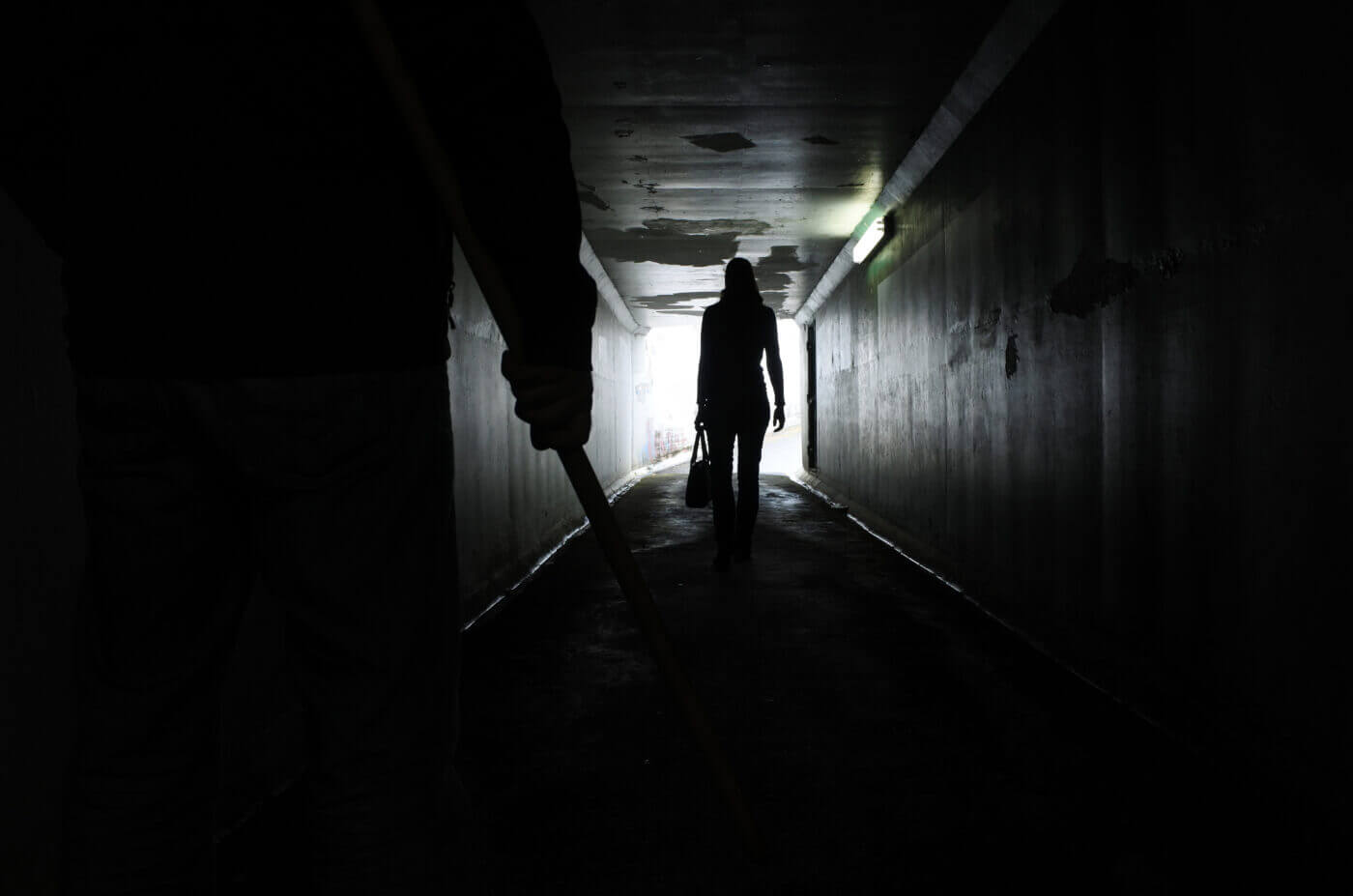 Stranger in dark tunnel and man with knife